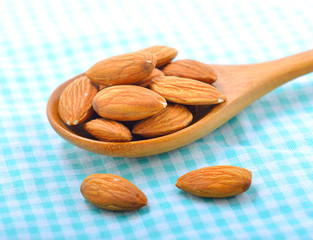 almonds on wood spoon