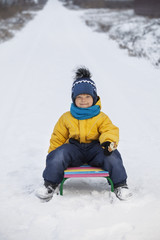 Fototapeta na wymiar happy boy on sled