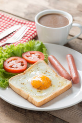 Breakfast, Egg in a hole with sausage and coffee.