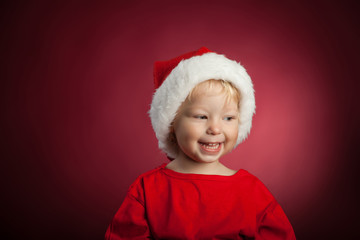 Happy baby in a Christmas cap