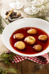 Sweet fried donuts in wine sauce