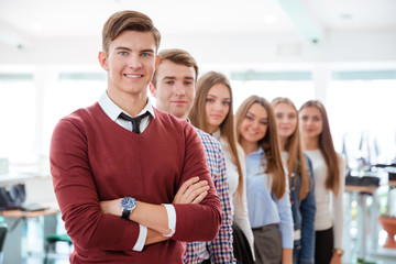 Smiling student standing in a line at universit