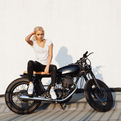Plakat Biker girl sitting on vintage custom motorcycle