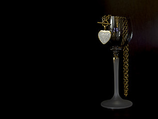 Glass of wine and gold heart necklace