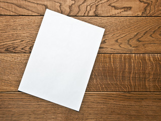 blank sheet of paper on a wooden table
