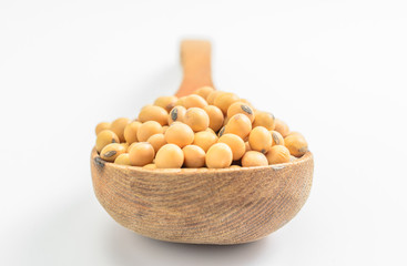 soybeans with wooden spoon on white background..
