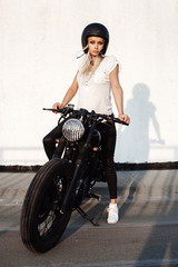 Fototapeta na wymiar fashion female biker girl with vintage custom motorcycle