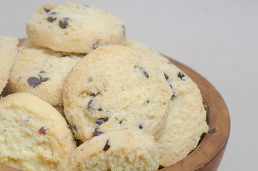 cookies in wooden bowl on brown background