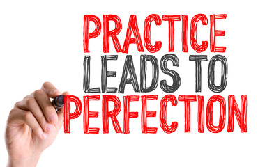 Hand with marker writing: Practice Leads to Perfection 