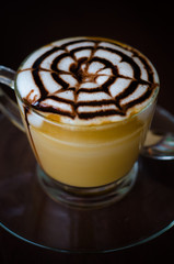 a glass of hot latte art coffee