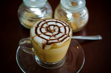 A glass of hot latte art coffee