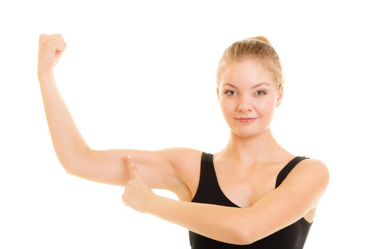 Fitness woman showing energy flexing biceps muscles.