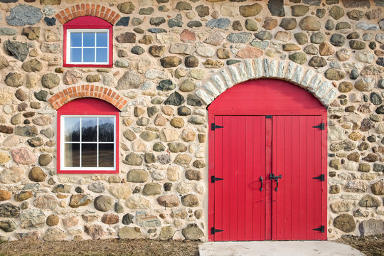 Bright Red Arched Door and Windows in a Stone Wall 