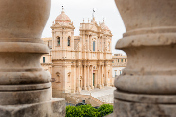 The baroque cathedral of Noto (UNESCO site in Sicily), seen through two columns