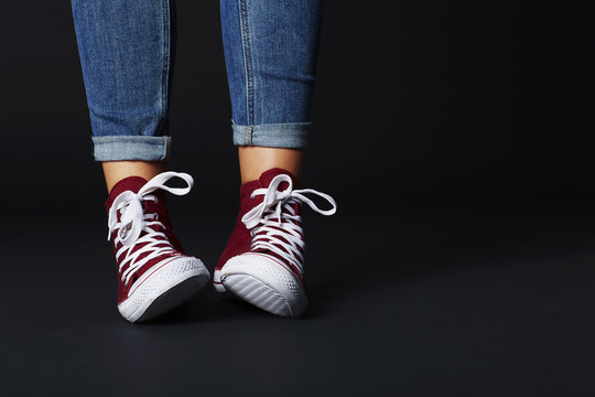 Young woman in jeans and sneakers