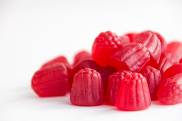 raspberry gummy in red on a white background 