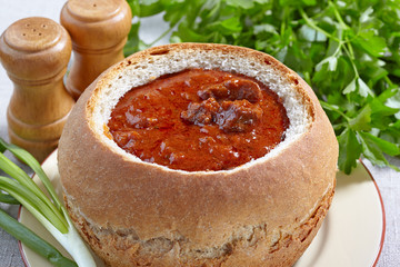 Czech cuisine. Goulash served in bread