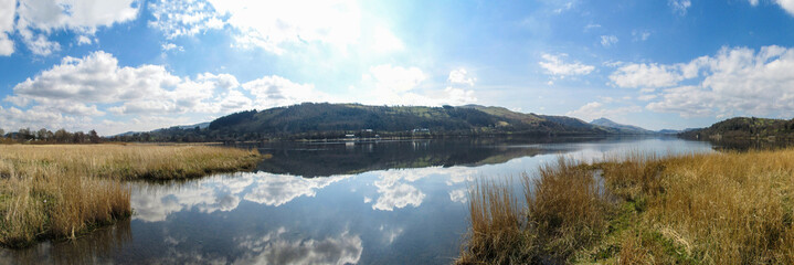 View across lake with cloudscape and reflections - 94003547
