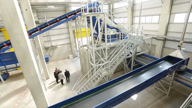 Inside of a waste management facility. Treatment and disposal of waste. Prevention of waste production through in-process modification, reuse and recycling. Convert waste materials into new products.