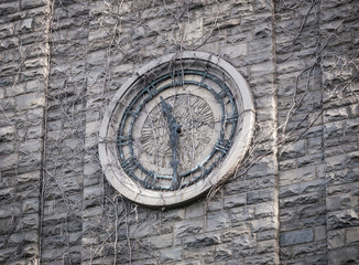 Clock Face made of Stone on an old Stone Barn