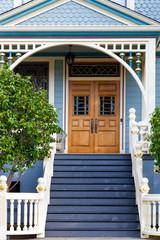 Front door of an old blue Victorian house  - 94011184
