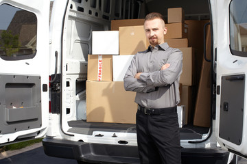 Young delivery man near truck.