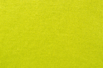 Vibrant green textile pattern as a background. Close up on neon green sweater material texture...
