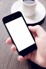 Young woman holding a smartphone with a white screen. Technology, finance, business, baking, online shopping and education concept. Natural window light.
