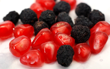 pomegranate fruits and dry aronia. food concept