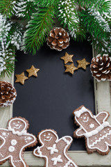 Black board for text, fir branches and gingerbread man