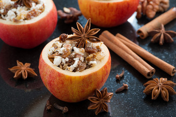 prepared for baking stuffed apples on a black background