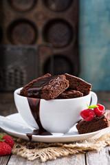 Brownies in stacked coffee cups with chocolate sauce
