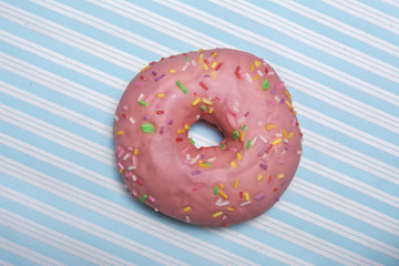 pink donut on blue striped background