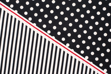 Polka dots and stripes pattern. Half white dots and half vertical stripes print on dark blue as background. © luanateutzi