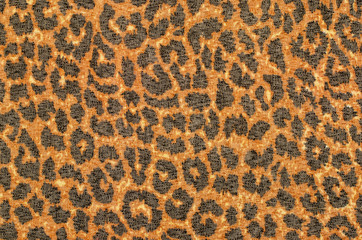 Brown and black leopard fur pattern. Spotted animal print as background.