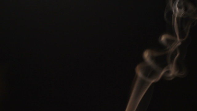 Smoke flowing in the air on a black background.