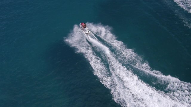 Aerial view on man enjoying water jet pack flyboard at the sea.
