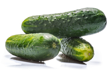 Cucumber and slices isolated over white background