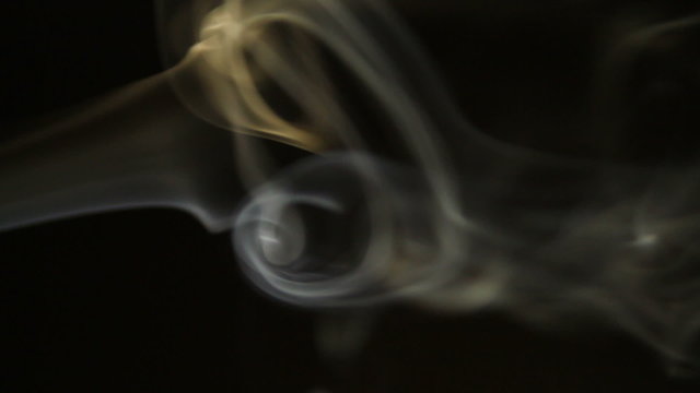 Smoke flowing in the air on a black background.
