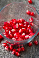 pomegranate seeds on wooden surface