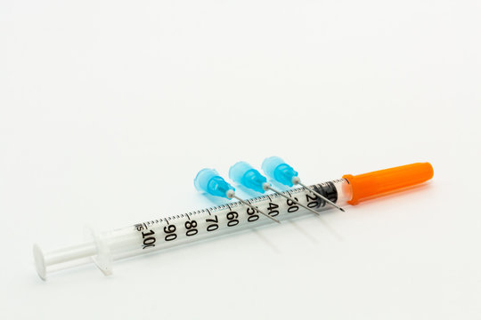 Three blue needles  and one 1ml disposable plastic syringe
