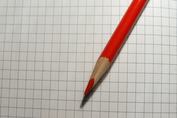 Macro photo of red pencil tip on the paper