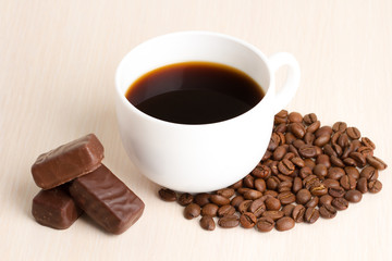 Coffee Cup and coffee beans on wooden table