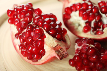 Juicy pomegranate on wooden table, closeup