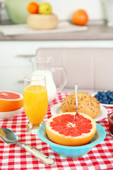 Healthy breakfast with fruits and berries on table in kitchen