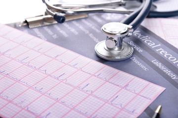 Stethoscope on cardiogram  sheet, closeup
