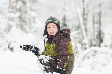 child out in a snowy forest