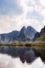 Mountain peak reflecting in a lake in Retezat mountains