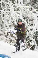Fototapeta na wymiar child out in a snowy forest