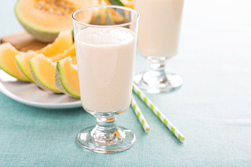 Healthy cantaloupe smoothie in a tall glass